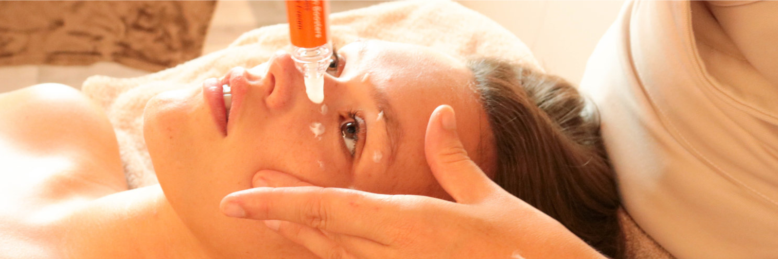 A client undergoing a cosmetic treatment using the Opsis Therapy products